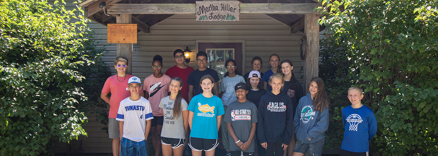 8th grade class outside a cabin at our 8th grade retreat location