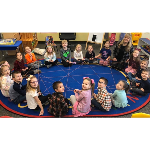 Students seated in a circle on a rug
